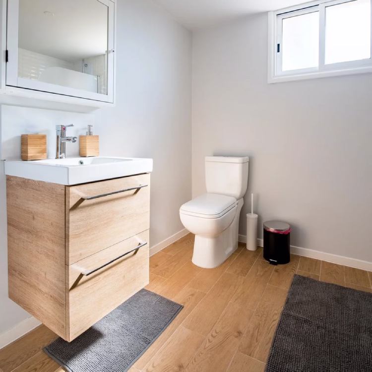 “Stylish basement bathroom featuring modern lighting, custom tile work, and a glass shower enclosure. showcasing the best bathroom renovation Toronto has to offer from one of the top bathroom renovation companies in Toronto