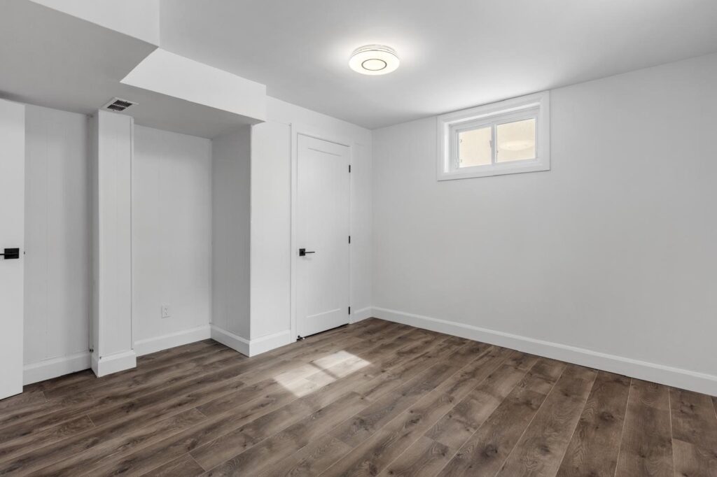 This bright, open basement was completely refinished with smooth walls, recessed lighting, and durable flooring. Designed to feel inviting and functional, it’s a perfect example of Mirage Renovations’ attention to clean craftsmanship and comfort.