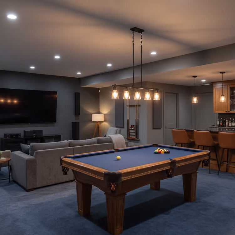 Spacious basement rumpus room featuring cozy seating, entertainment area, and warm ambient lighting.
