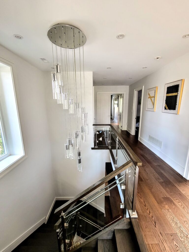 A sleek staircase transformation featuring updated railings and finishes. A subtle upgrade that enhances flow and elevates the home’s overall aesthetic.